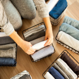 organizing clothes in baskets