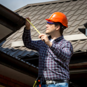 man inspecting roof